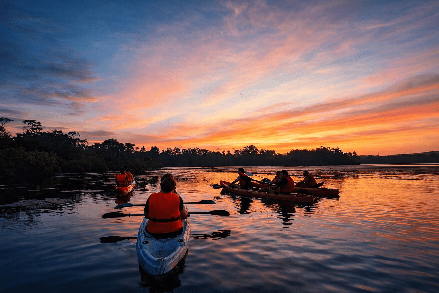 Guests kayaking calmly on Mawella Lagoon with lifejackets