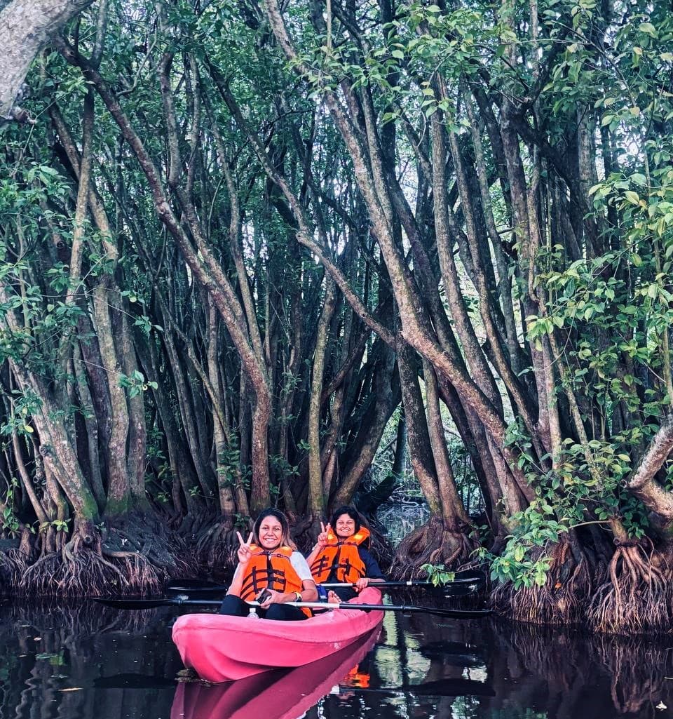 Visitors enjoying food by the peaceful Mawella Lagoon environment near Tangalle Sri Lanka